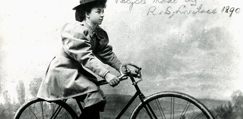 Victorian woman riding bicycle