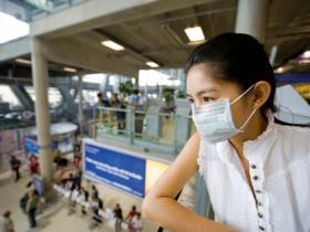 woman at airport wearing a face mask