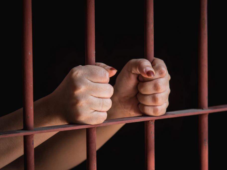 woman behind bars