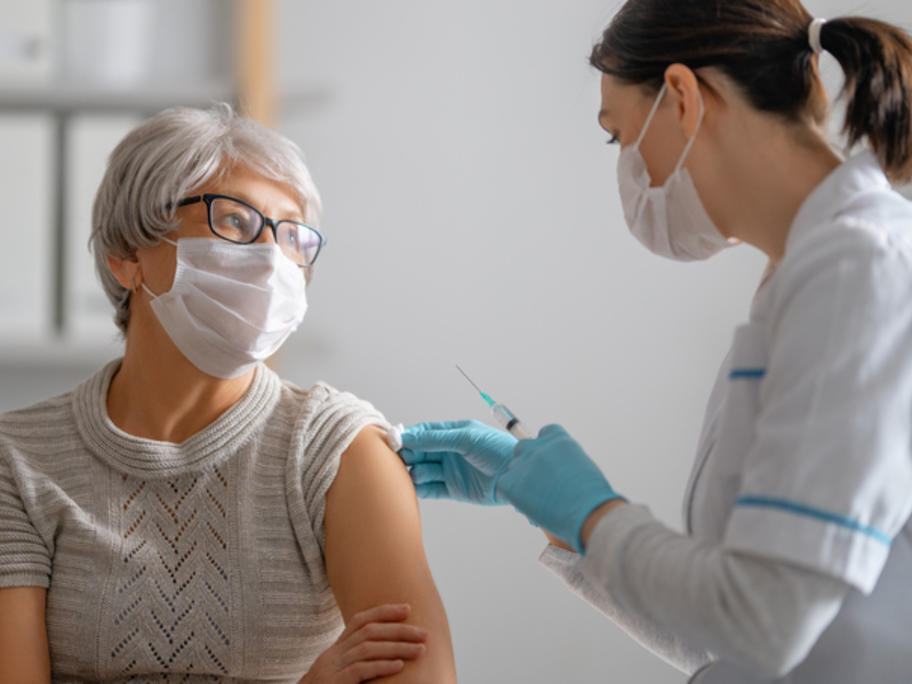 senior woman having COVID vaccination