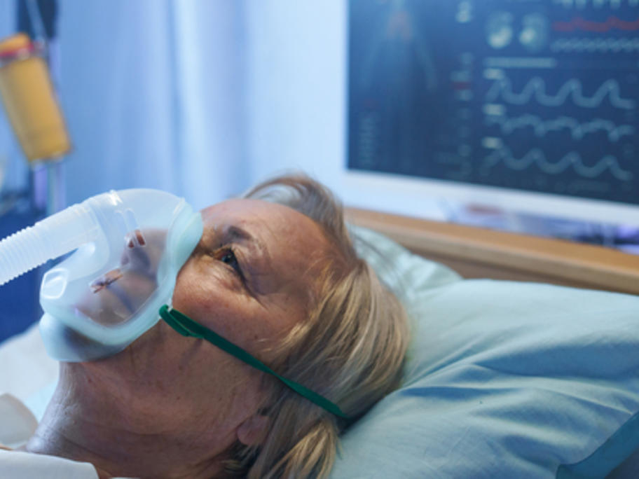woman in hospital with oxygen mask