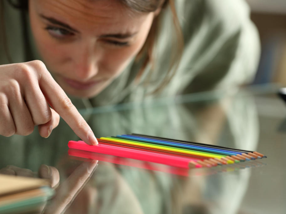 Young woman arranging pencils neatly