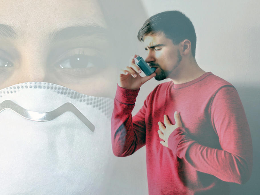 man using asthma inhaler against background of mask - signifying coronavirus