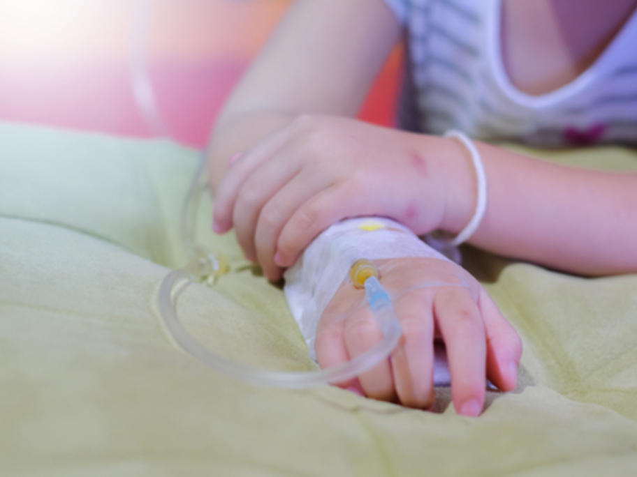 close up of young girl's hads - she's having an IV infusion