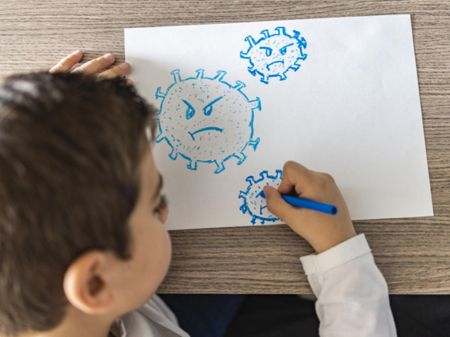 boy drawing nasty-looking coronaviruses