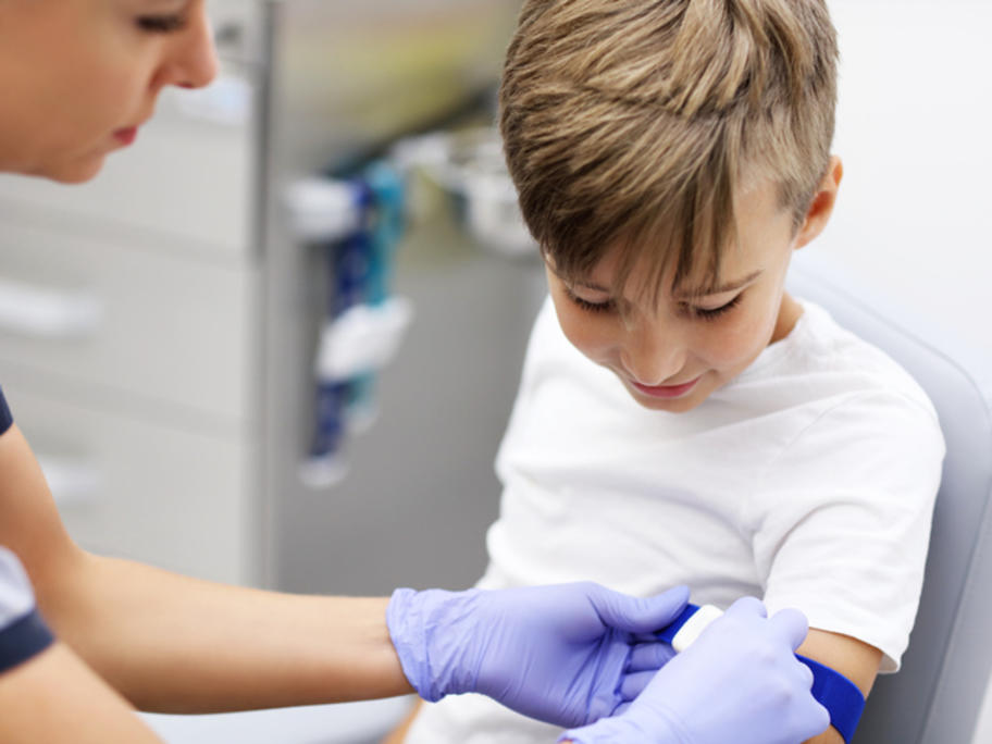 Young boy having blood taken
