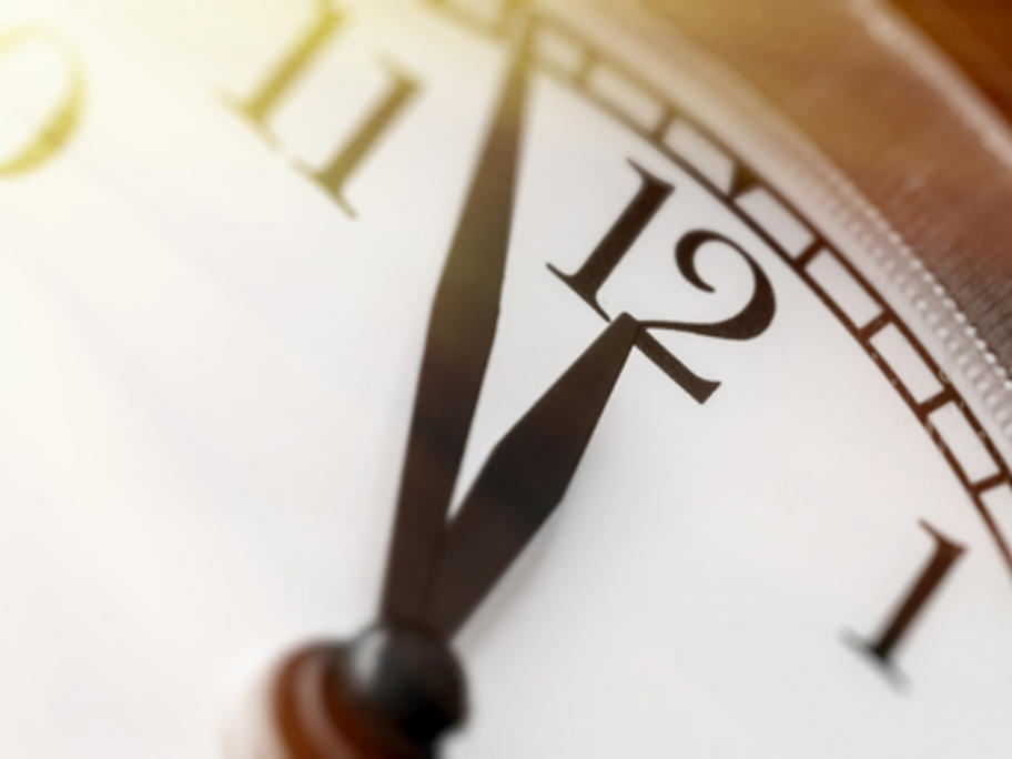 clock with the time 3 minutes to noon