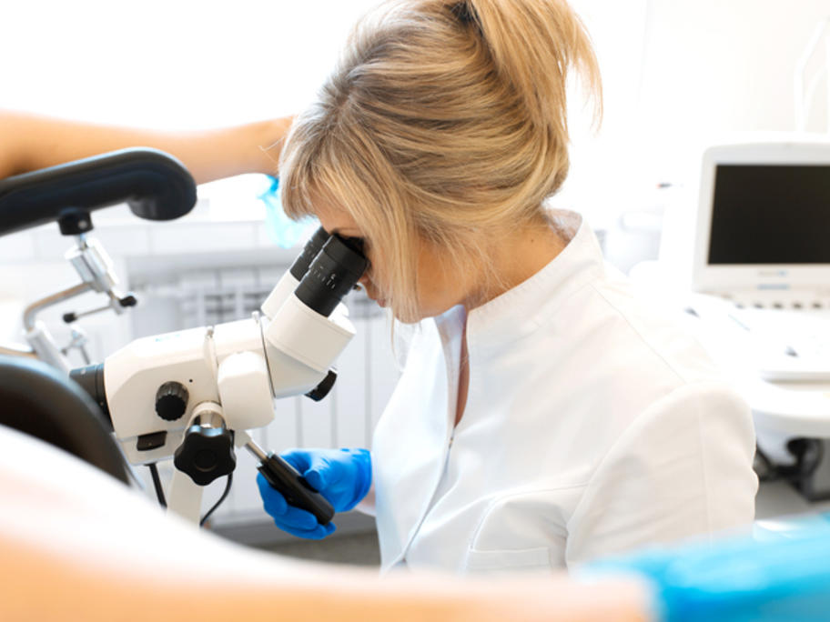 female gynaecologist perfroming colposcopy