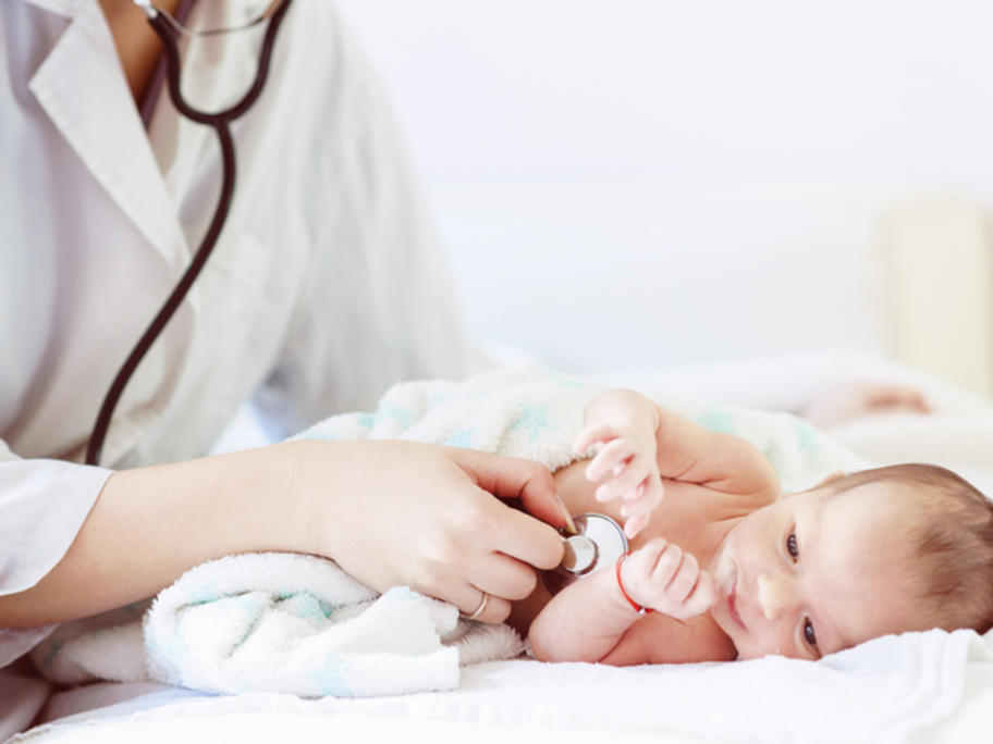 doctor listening to baby's chest