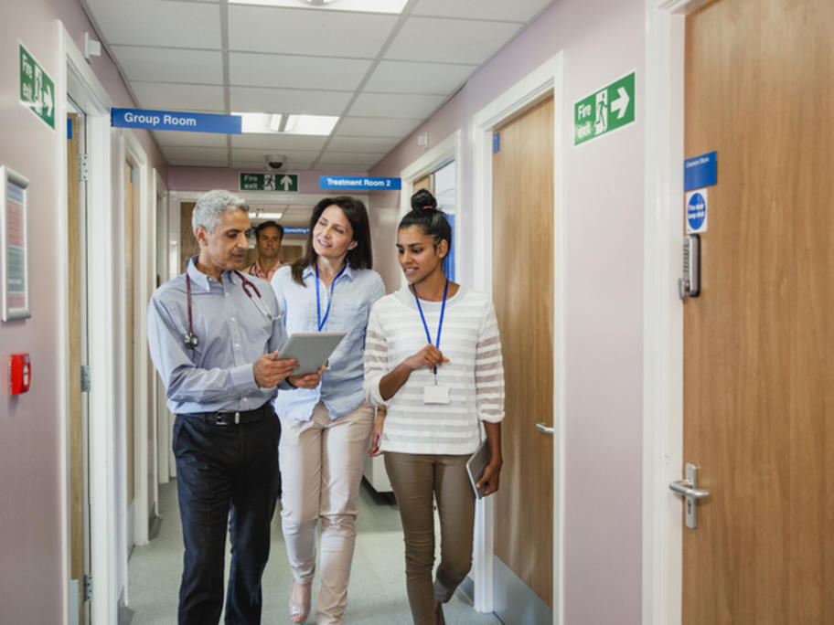 doctors and allied health therapists talking in a corridor