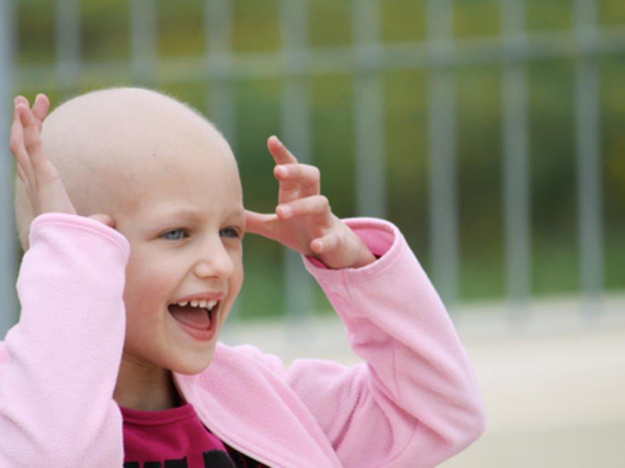 happy child with hair loss due to cancer therapy