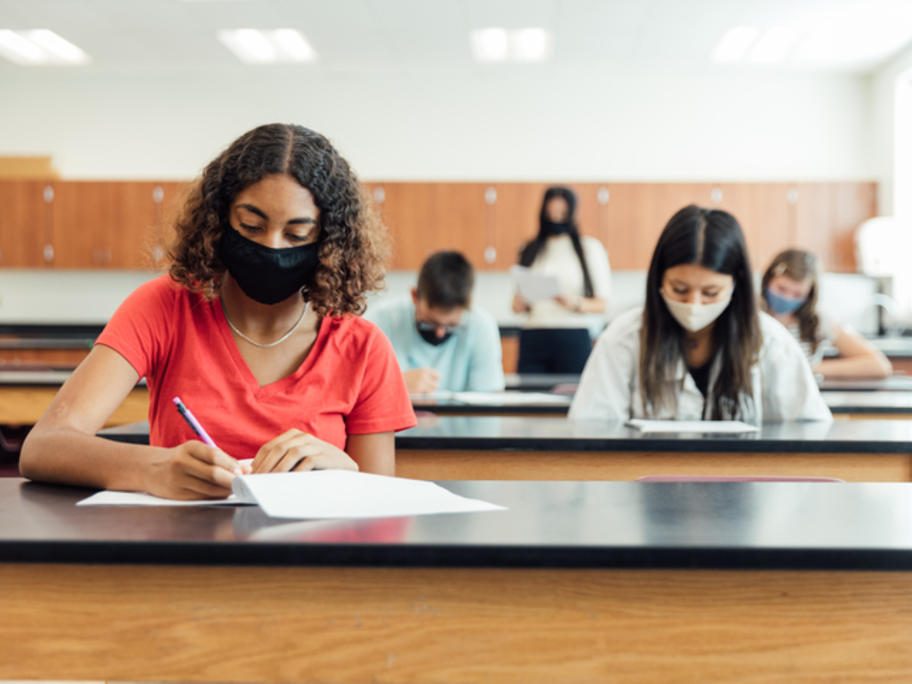 People wearing masks while taking exam