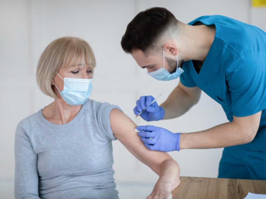 Middle aged woman having SARS-CoV-2 vax