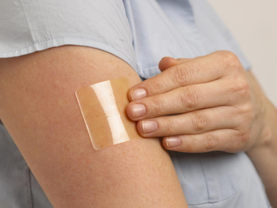 Woman with nicotine patch on her arm