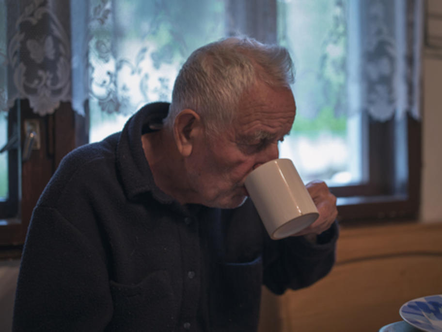 senior man drinking tea at home