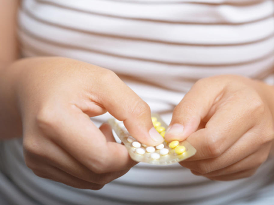 woman taking oral contraceptive pill