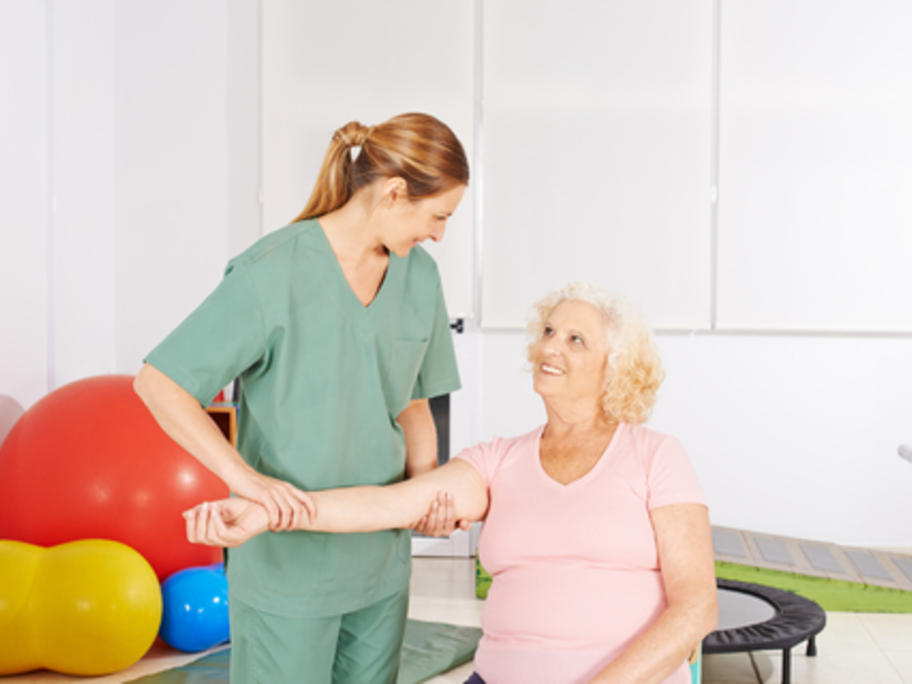 senior woman working with physiotherapist