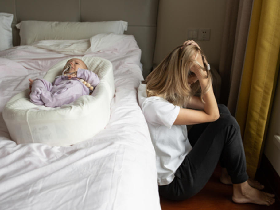 depressed young mother and baby