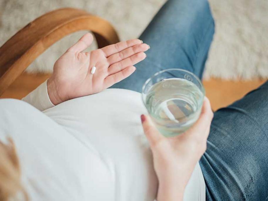 pregnant woman taking pill
