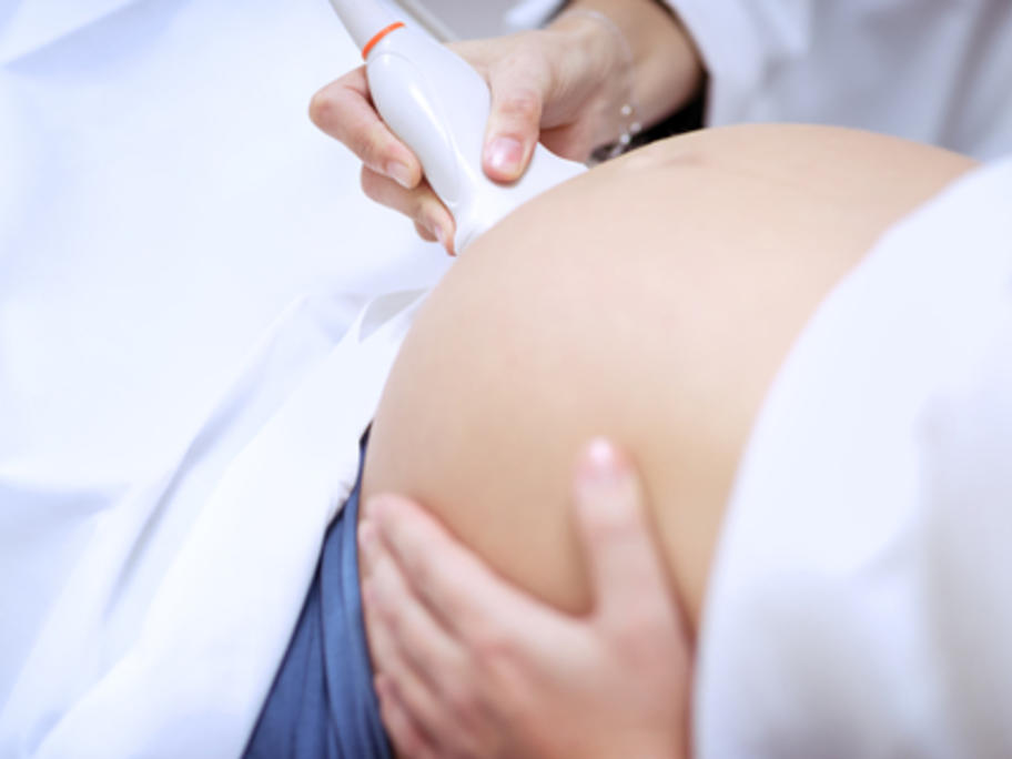 woman in third trimester having ultrasound 
