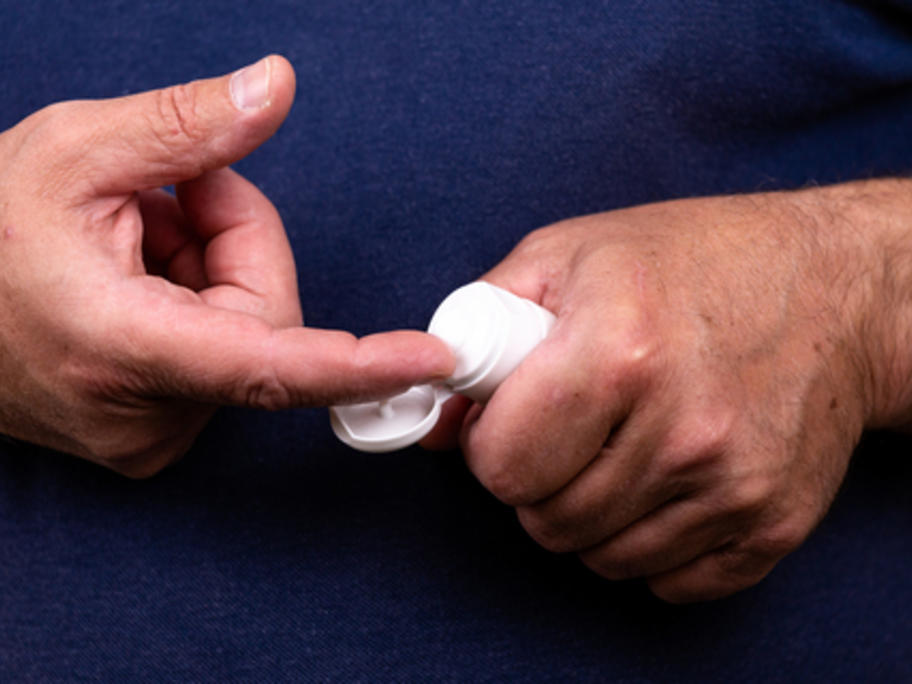man getting cream out of tube