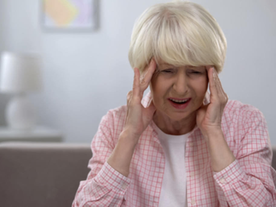 senior woman with headache pain in her temples