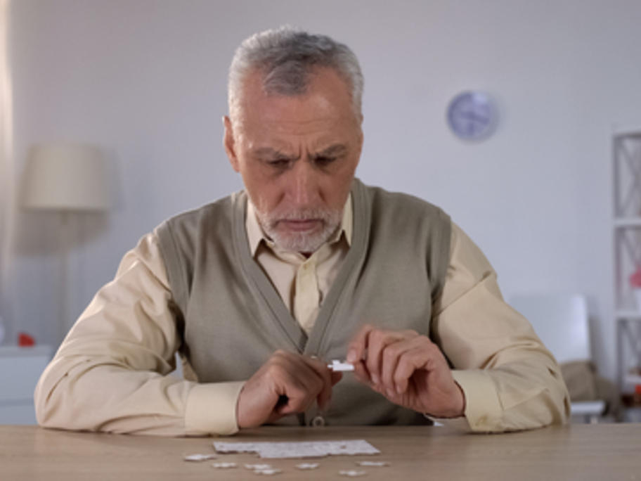 senior man doing a jigsaw puzzle