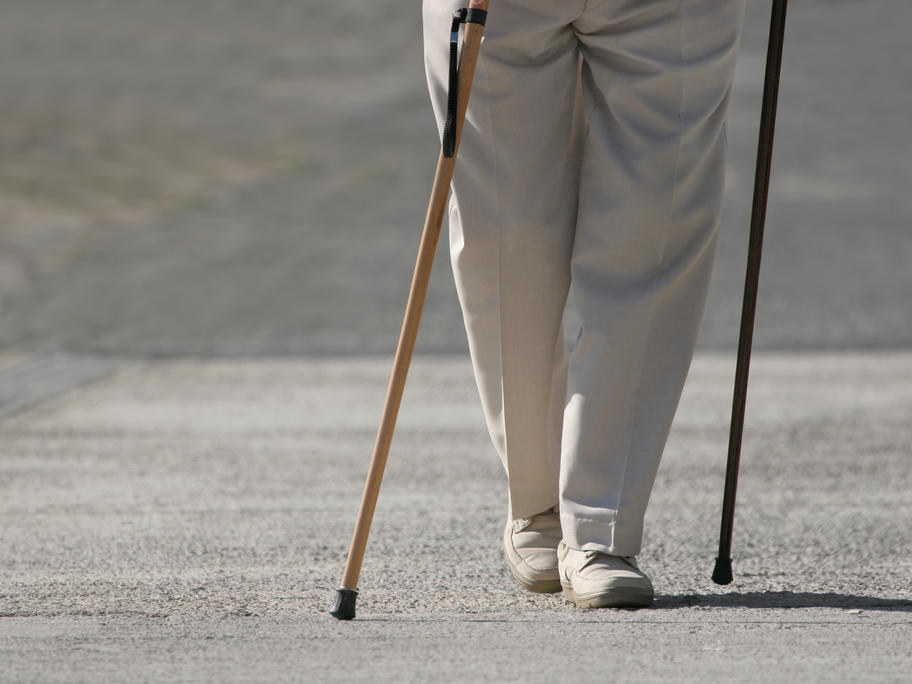 senior man walking with 2 canes