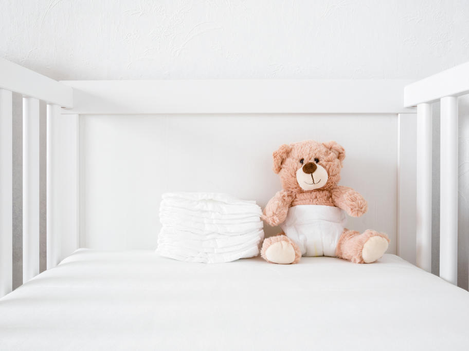 Teddy in cot