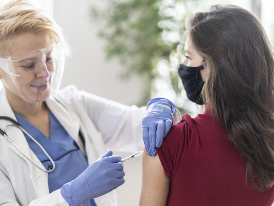 Teenager getting COVID vax