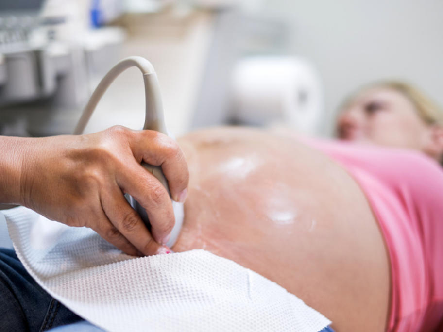 heavily pregnant woman having ultrasound