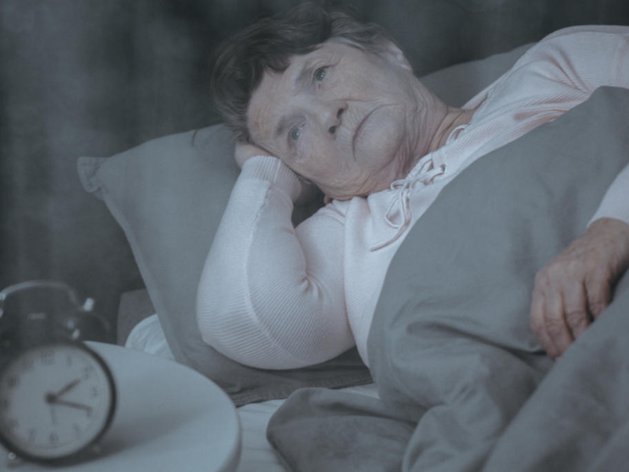 senior woman awake in bed in the small hours
