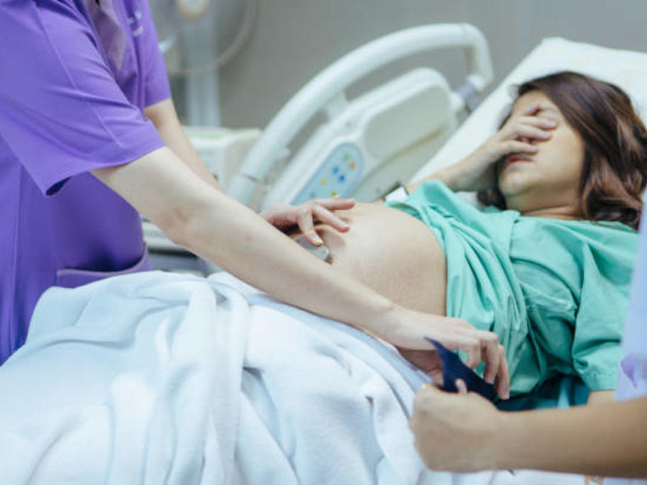 woman in labour with healthcare worker