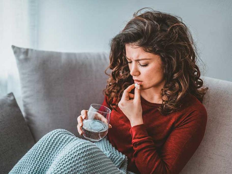 woman taking pill
