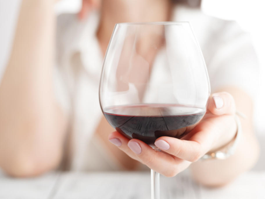 Young woman drinking red wine