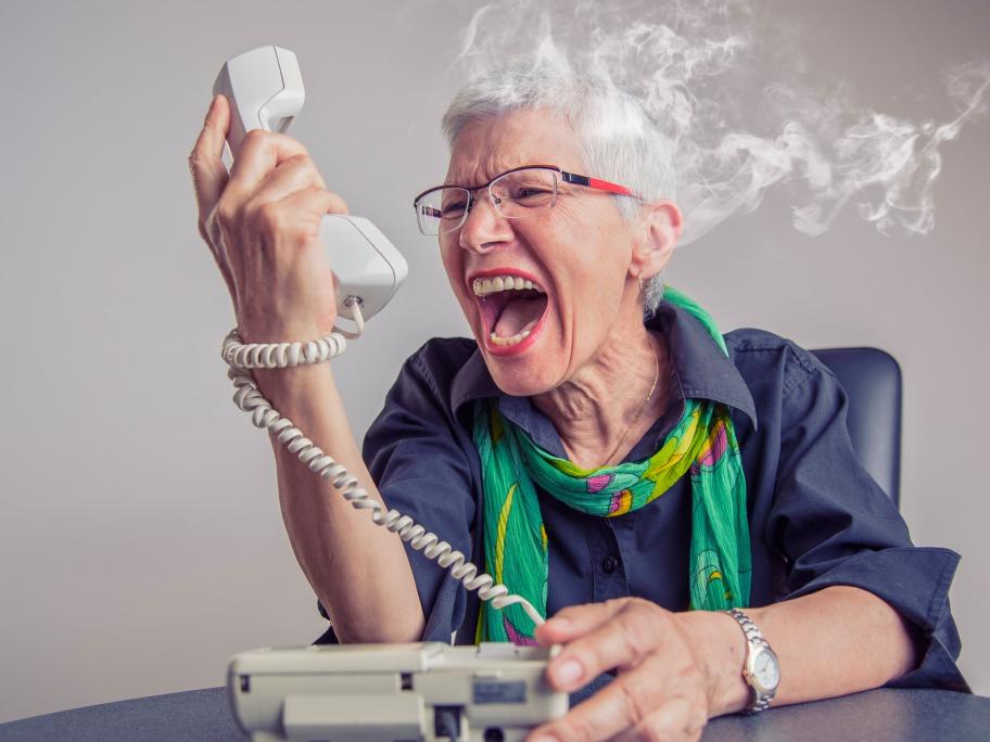 Senior screaming at phone