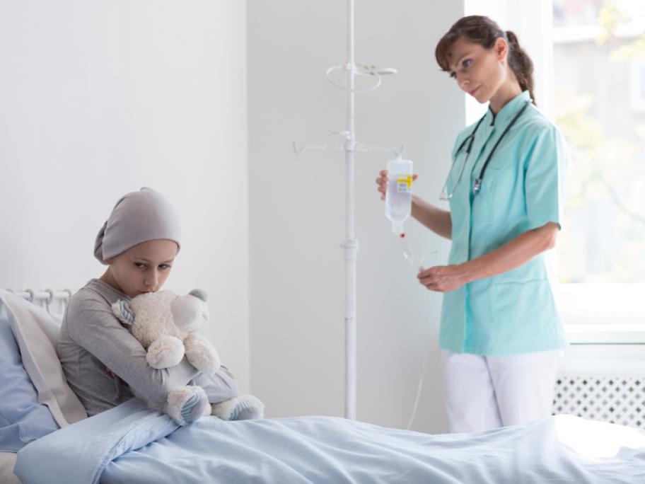 child with cancer in hospital with nurse