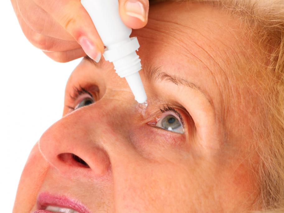 Senior woman using eye drops