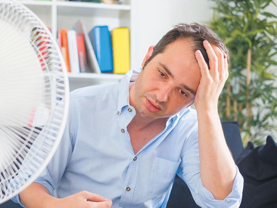 Stressed hot sweaty man