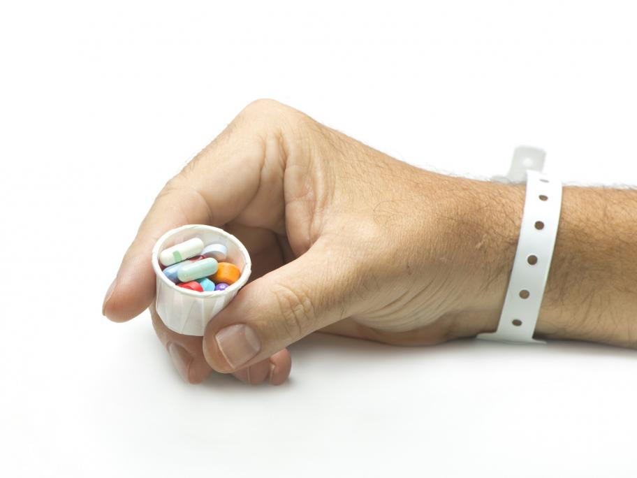 Hospital patient holding pills