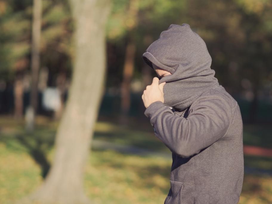 man hiding face