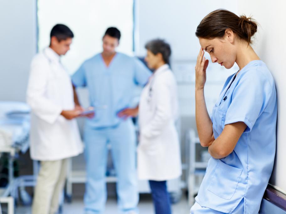 Stressed female medical student at ward round