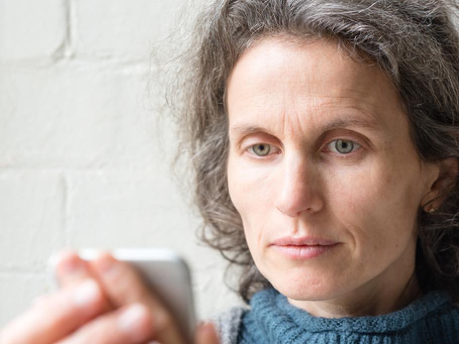 Woman in her 50s looking at mobile phone