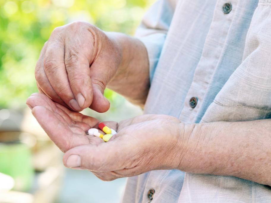 Woman aged over 65 holding pills