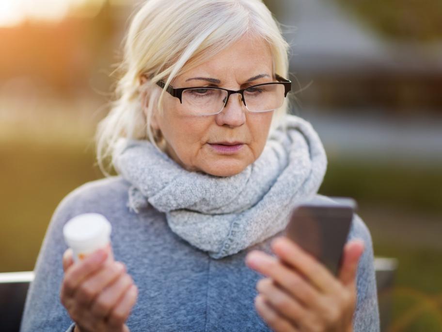 older woman with pill