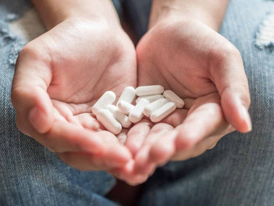 Paracetamol pills in cupped hands