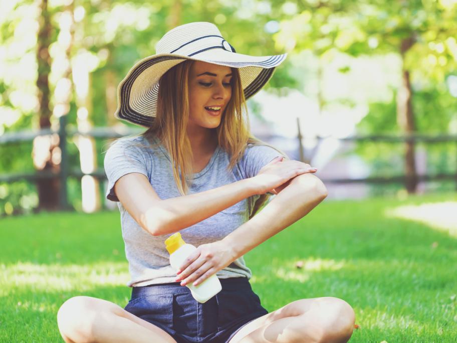 Woman using suncreen