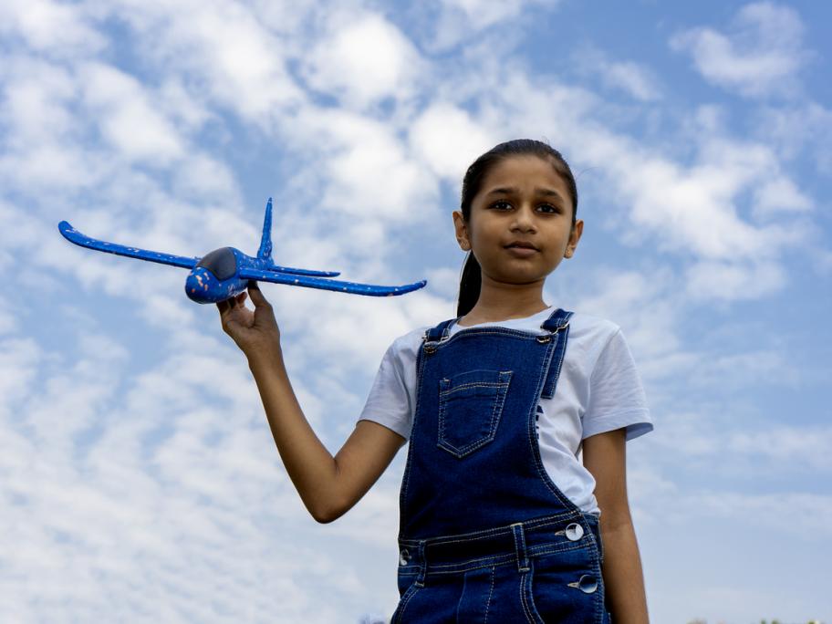 Child holding toy plane
