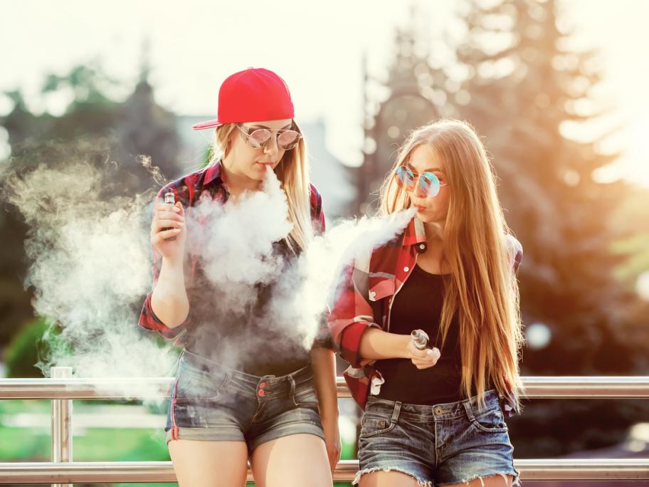 Two young women vaping