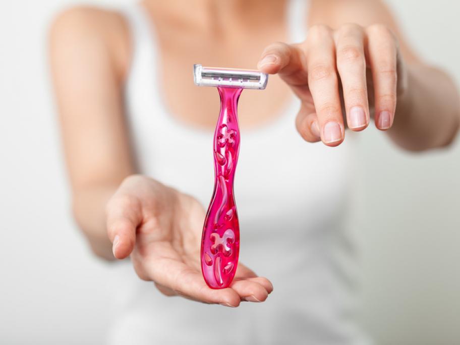 Woman holding pink razor